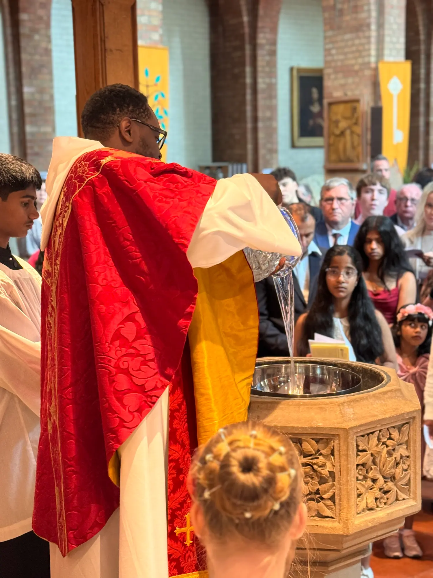 Water poured at the font during a baptism