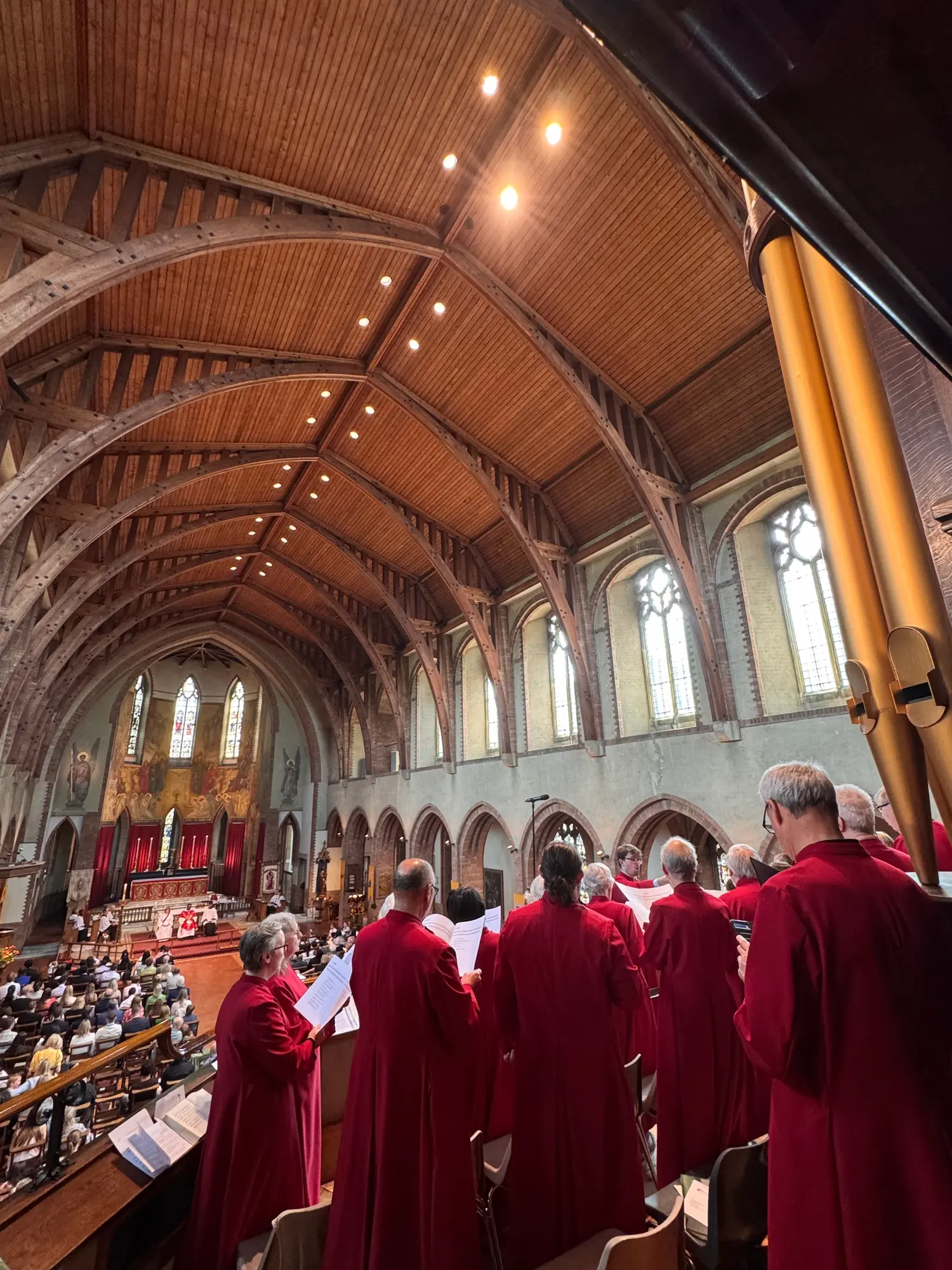 The choir singing in the west gallery, looking down the nave towards the altar