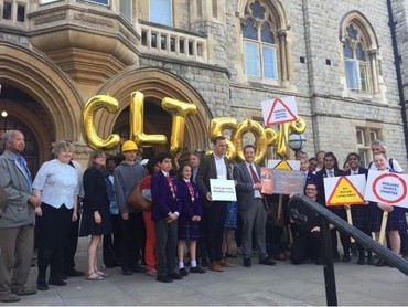 Campaigners outside the town hall with gold balloon letters and placards