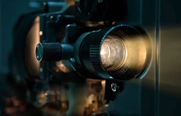Close-up of a vintage film projector lens