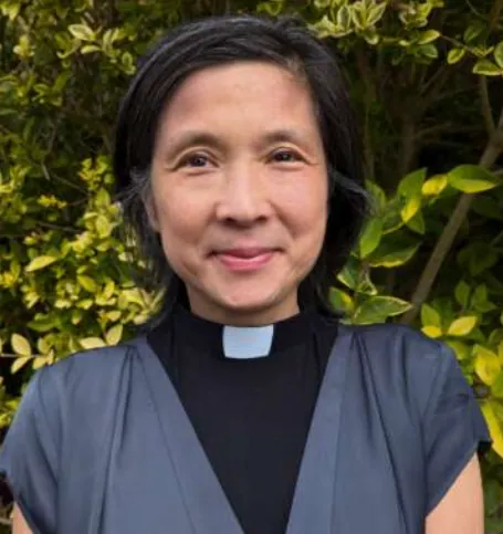 Portrait of the Revd Jeanny Wang in a clerical collar, smiling
