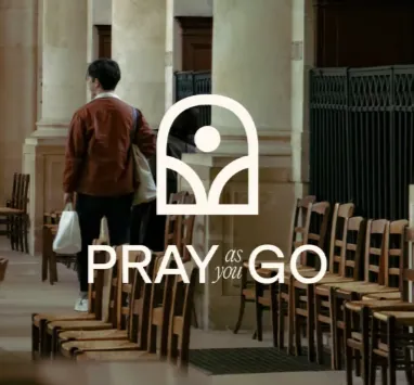 Pray as you Go app logo over a photo of someone walking through a colonnade
