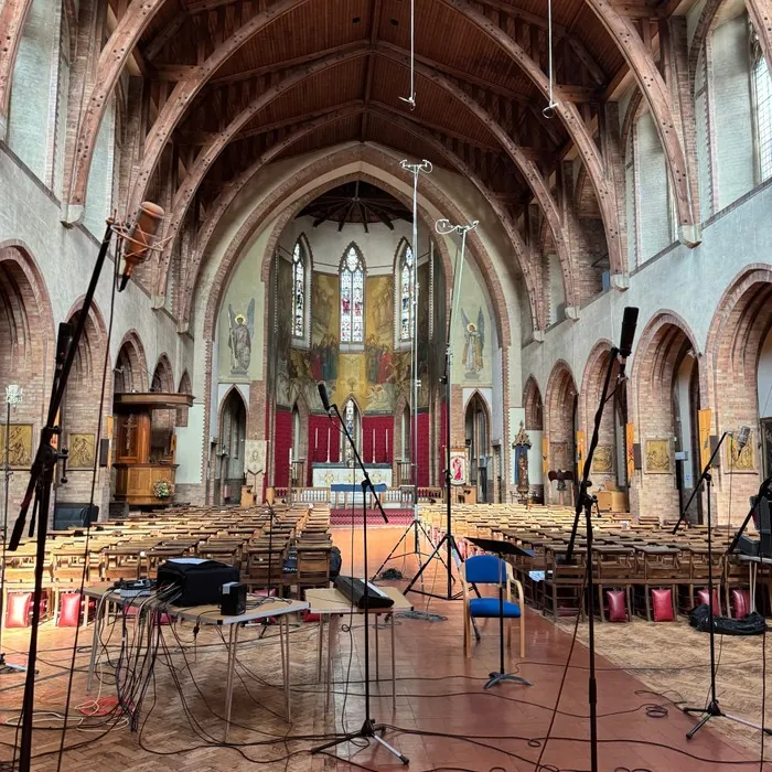 Microphones and recording equipment set up in the empty church nave